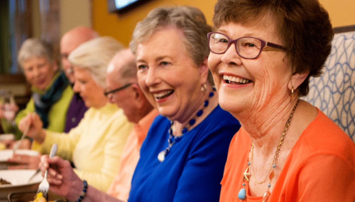 Group of older residents laughing and enjoying one another's company.