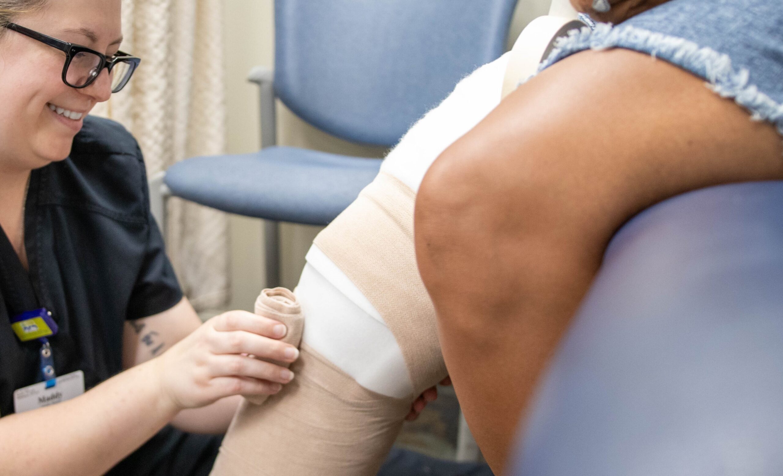 Nurse wrapping a knee