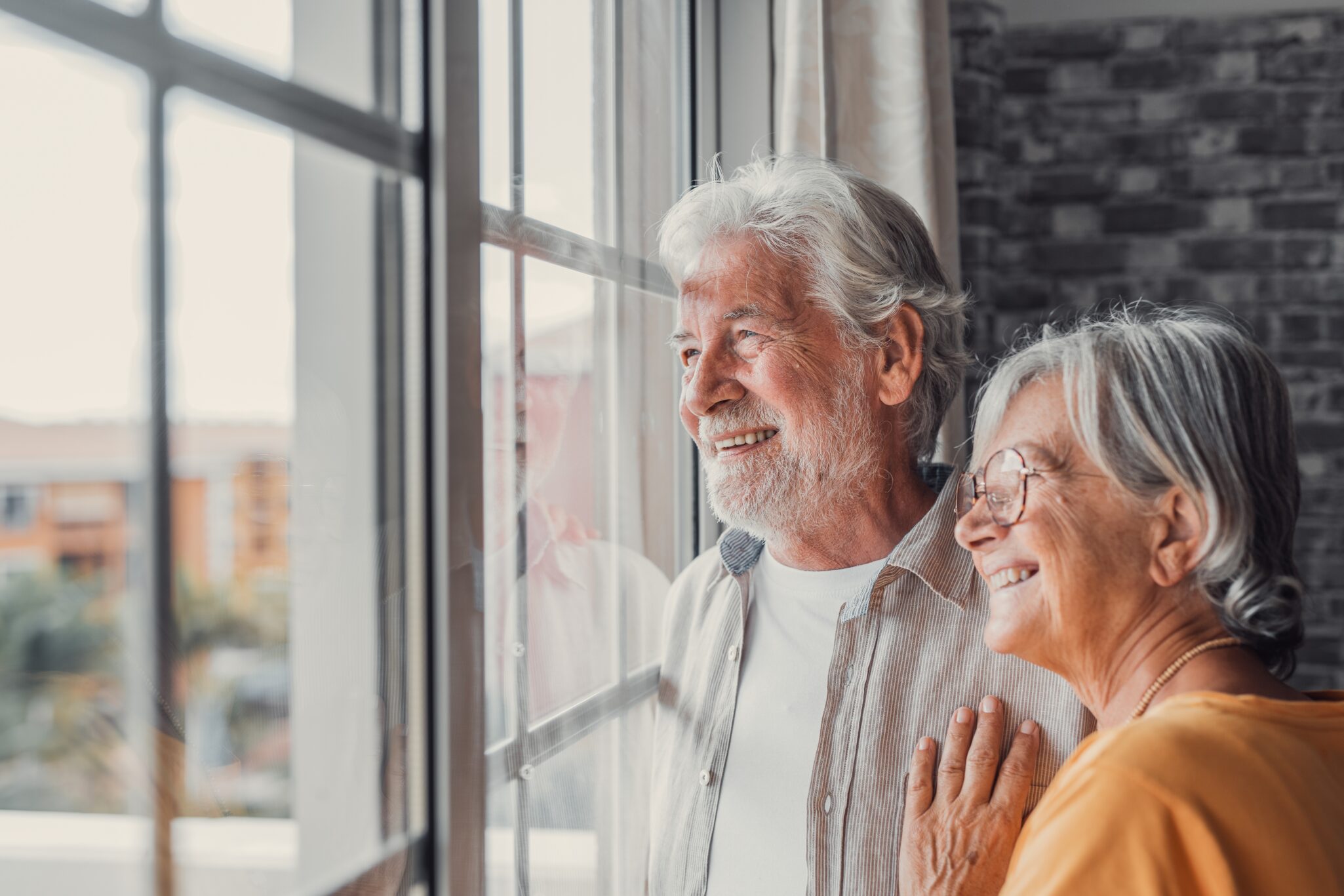 Senior couple looking out window